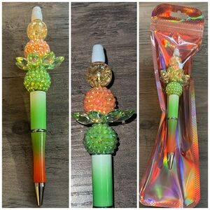 Handmade green and orange beaded pen